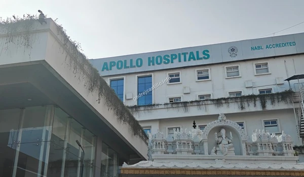 Exterior of NABL accredited Apollo Hospitals featuring a beautiful white temple structure at the front near Godrej Castillo.