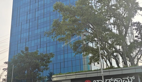 Exterior glass facade of the Broadcom building, highlighting the modern commercial infrastructure and thriving tech sector surrounding the Godrej Castillo project