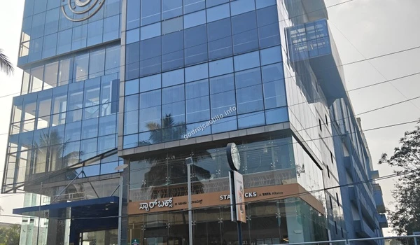 A wide shot of the contemporary multi-level business center hosting a Starbucks shop, offering great lifestyle amenities near Godrej Castillo.