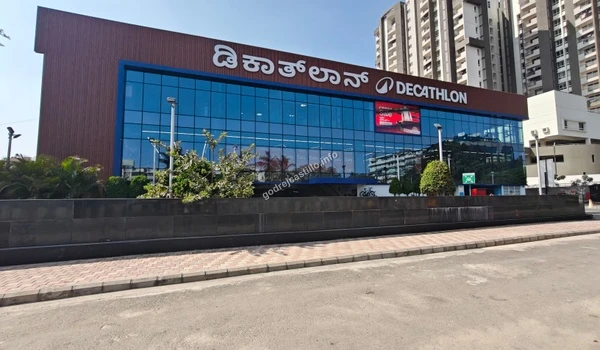 Large Decathlon sports store exterior with a wide glass facade providing sporting goods and equipment near Godrej Castillo