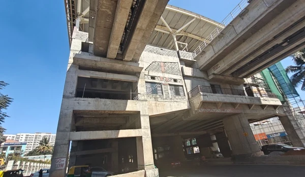 Sunlight highlighting the robust architecture of the elevated metro corridor being built in close proximity to Godrej Castillo