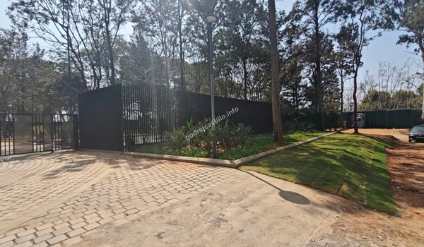 Close up of the lush green landscaping and manicured lawn surrounding the secure perimeter of Godrej Castillo