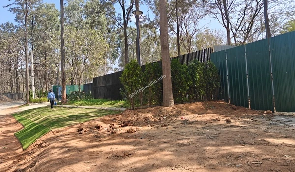 View of the expansive entrance plaza at Godrej Castillo showcasing the high-quality stone paving and surrounding nature