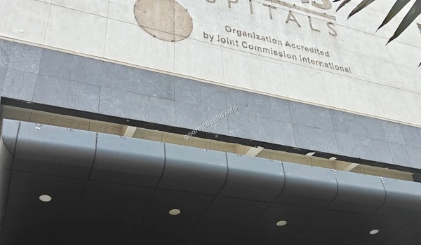 Close-up of the Fortis Hospitals entrance canopy and JCI accreditation sign ensuring quality care for Godrej Castillo residents.