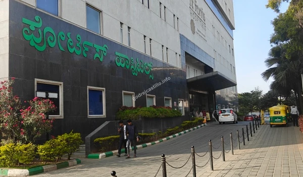 Main entrance of Fortis Hospitals showing patient drop-off area, providing premium medical care near Godrej Castillo.