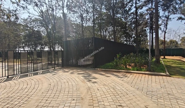 Detailed view of the modern black slat fencing and secure gate design at the Godrej Castillo entry point