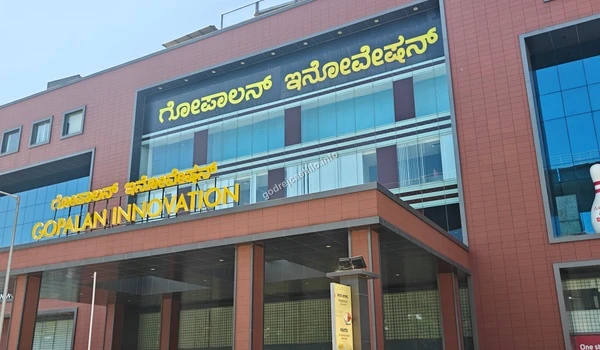 The impressive multi-level facade of Gopalan Innovation Mall displaying bright yellow signage, adding immense value to the neighborhood of Godrej Castillo