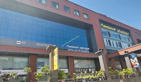 Broad view of the Gopalan Workspace exterior showcasing large glass panels and the Taco Bell outlet, providing easy dining options for Godrej Castillo residents
