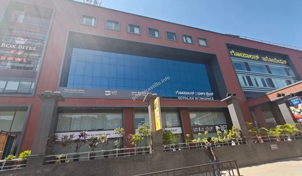 The grand brick and glass facade of Gopalan Workspace and Innovation Mall featuring retail options like Taco Bell, providing lifestyle convenience for Godrej Castillo