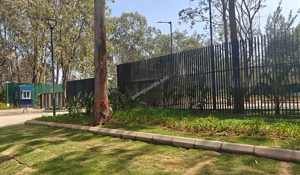 The high-quality stone-paved internal roadway at Godrej Castillo leading into the residential blocks surrounded by scenic nature