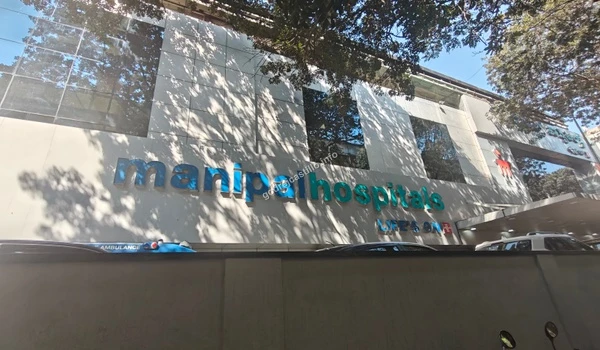 Main signage and entrance building of Manipal Hospitals ensuring excellent multi-specialty care near Godrej Castillo.