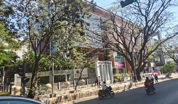 A wider perspective of the tree-lined road passing by the Mantri Elegance business park, illustrating the excellent infrastructure surrounding Godrej Castillo