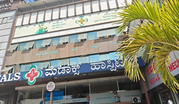 Exterior facade of Medax Hospitals highlighting advanced technology and trauma care accessible from Godrej Castillo.