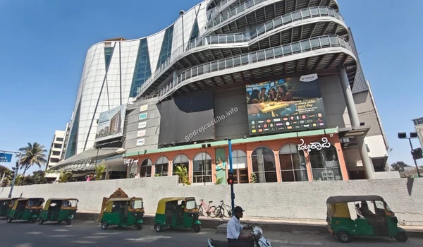 Prominent ground-level entrance of Nexus Vega City mall featuring the Hatti Kaapi cafe, providing excellent lifestyle amenities for Godrej Castillo residents.