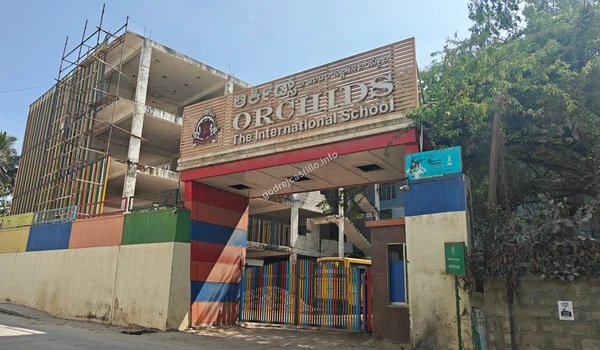The colorful exterior and main gate of Orchids The International School, providing diverse learning choices in the vicinity of Godrej Castillo