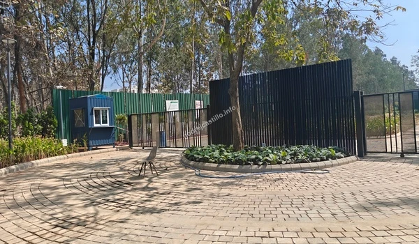 A detailed look at the modern black slat perimeter security fencing and the vibrant green lawn at the Godrej Castillo project site
