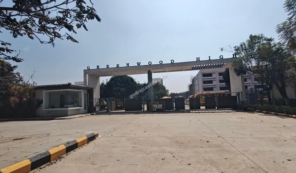 Wide angle view of the Greenwood High entrance arch, displaying the quality educational infrastructure present near Godrej Castillo