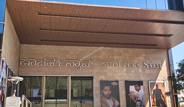 Close up of the sleek architecture and glass storefronts at Shoppers Stop, providing luxury apparel shopping just a quick drive from Godrej Castillo