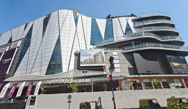 The grand Nexus Vega City mall captured from the street level, showcasing its premium retail scale and convenient proximity to Godrej Castillo.