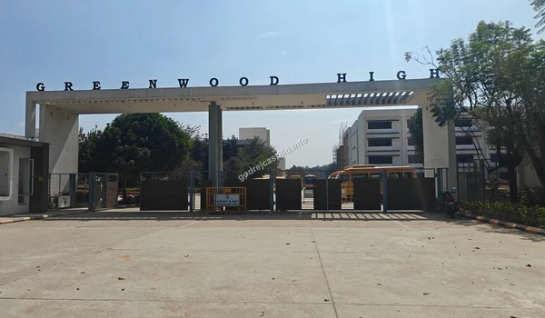 The wide entrance road leading into the Greenwood High campus, exemplifying the prime educational conveniences surrounding Godrej Castillo