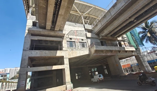 Street level view of the elevated metro rail construction providing seamless rapid transit connectivity to the Godrej Castillo project