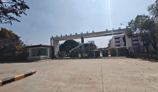 Greenwood High's prominent entrance gate seen under clear daylight, securing the educational prospects for Godrej Castillo families