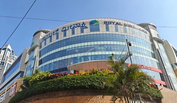 The grand exterior of Royal Meenakshi Mall featuring a wide array of retail stores, dining options, and entertainment near Godrej Castillo