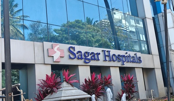 Close-up of the prominent Sagar Hospitals branding on the building exterior located near the Godrej Castillo project.