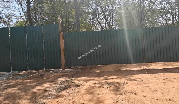 Professional green construction hoarding at the Godrej Castillo site entrance indicating ongoing development progress