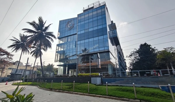 A broad street perspective of the commercial Starbucks building, showcasing its sleek architecture in the vicinity of Godrej Castillo.