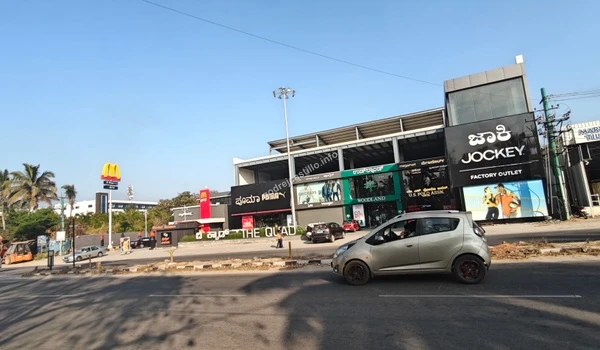 View of The Quad shopping complex featuring McDonald's, Puma, Woodland, and Jockey outlets easily accessible from Godrej Castillo