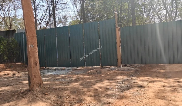 A serene tree-lined walking path near the entrance gate of Godrej Castillo providing a natural canopy for pedestrians