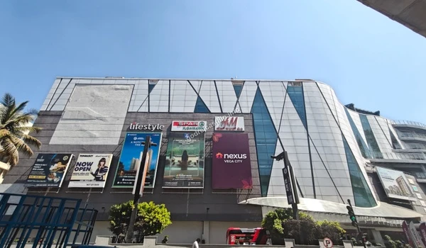 The expansive modern exterior of Nexus Vega City mall, a premier shopping and entertainment landmark accessible from Godrej Castillo.
