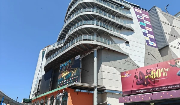 An angled shot of the Vega City mall showing its curved architectural balconies and multiple retail brand signages close to Godrej Castillo.